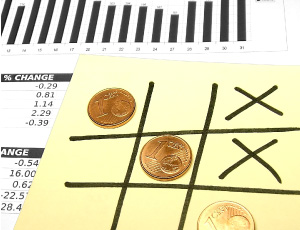 close up photo of naughts and crosses board and tax statements